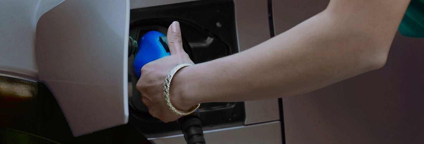 A close up exterior shot of an RZ being plugged in to charge.